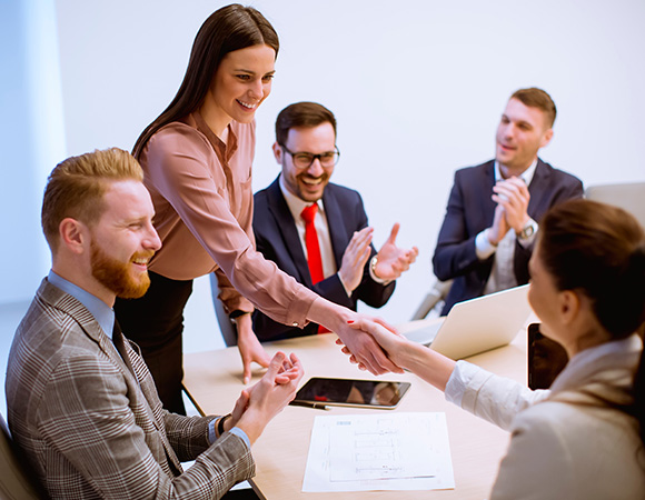 business professionals shaking hands in a meeting celebrating partnership and collaboration with twelve key points to success