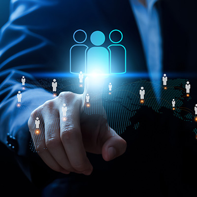 business professional selecting three user icons on a digital interface representing team collaboration and connection