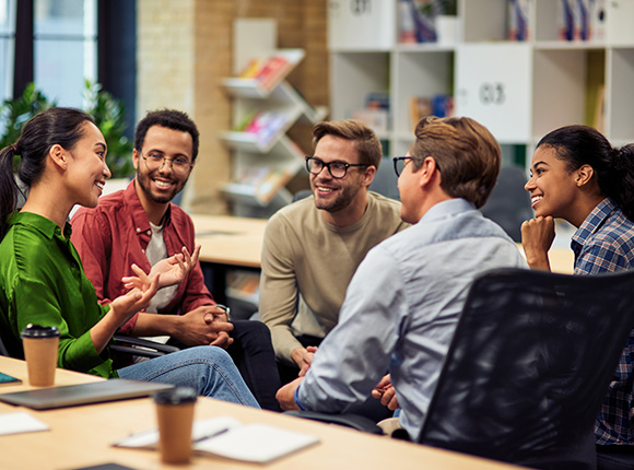 group of five diverse professionals engaged in a discussion in a modern office setting collaborating on ideas and strategies for project twelve