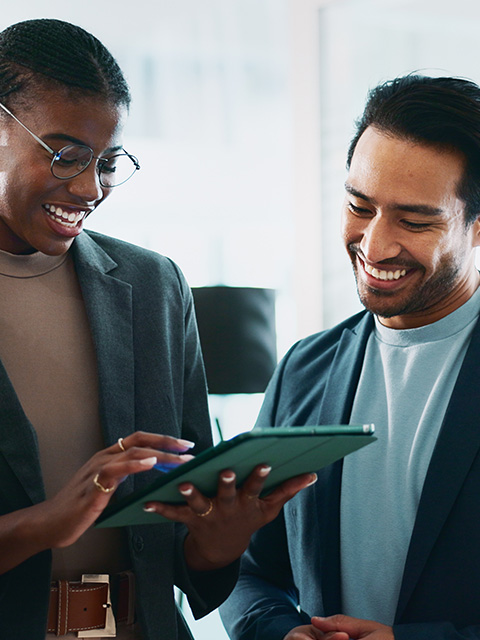a woman and a man engaged in discussion while reviewing content on a digital tablet in a modern office setting showcasing teamwork and collaboration in a professional environment emphasizing three key ideas
