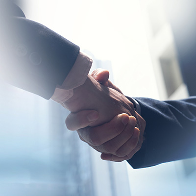 handshake between two business professionals symbolizing partnership and collaboration in a corporate setting for growth and success