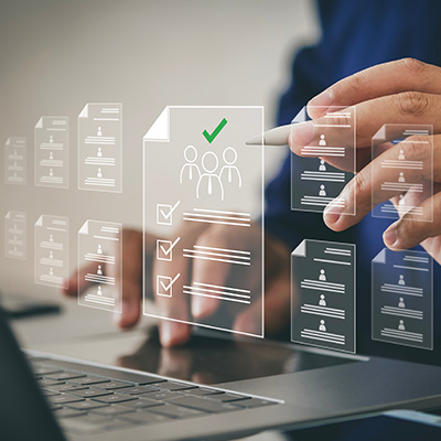 person using laptop with digital documents and checklists for three users